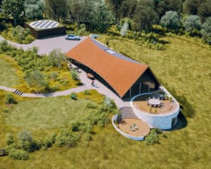 Aerial view of the sweeping peg tiled roof at Reservoir View, a transformed landscape designed by Hawkes Architecture.