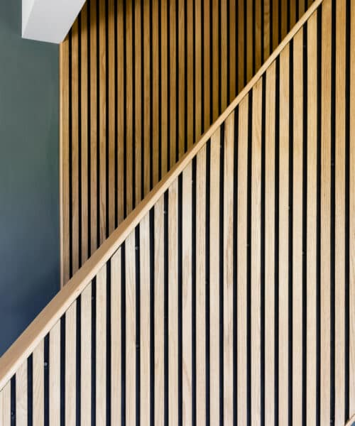 Interior detail of panelling along the staircase at Whitsunden Oast, a contemporary extension & barn conversion designed by Hawkes Architecture.