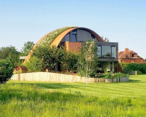 Garden view of the arch in bloom at Crossway, a Para 80 (PPS 7), energy efficient Passivhaus. Designed by Hawkes Architecture and featured on Channel 4's Grand Designs.