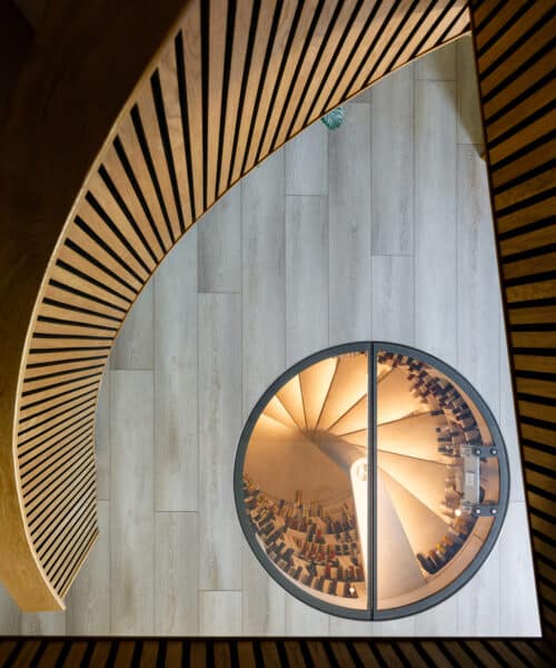 Entrance hall showing the glass topped underground wine vault at Whitsunden Oast, a contemporary extension & barn conversion designed by Hawkes Architecture.