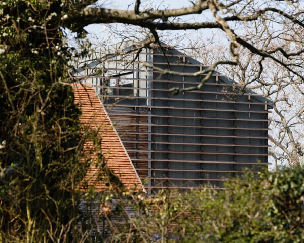 Exterior detail showing the veil of louvres wrapped around the building at Echo Barn, a Para 55 energy efficient passive house. Another grand design by Hawkes Architecture.